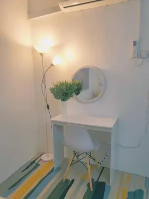 a desk with a potted plant and a mirror at CASA AIRA Cozy & Comfy Home in Kampong Kepayang