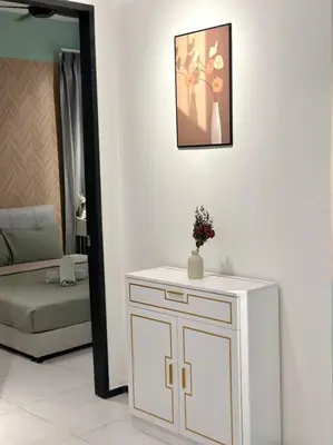 a bathroom with a white cabinet with a vase on it at Urban Emerald Seaview 6Pax 3Queen 3Room 2Bath 2Carpark with Infinity Pool in Jelutong
