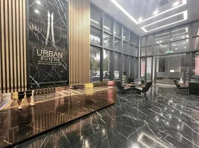 a lobby with a united states sign in a building at Urban Emerald Seaview 6Pax 3Queen 3Room 2Bath 2Carpark with Infinity Pool in Jelutong