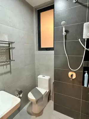 a bathroom with a toilet and a sink and a shower at Urban Emerald Seaview 6Pax 3Queen 3Room 2Bath 2Carpark with Infinity Pool in Jelutong