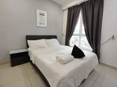 a bedroom with a large white bed with a window at 2bedroom 2bath 13th Seaview MansionOne Gurney in George Town