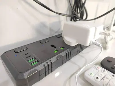a device hooked up to a charger and a remote control at 2bedroom 2bath 13th Seaview MansionOne Gurney in George Town