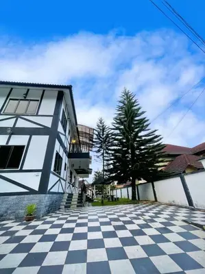 a building with a checkered floor in front of it at Bukit Cottage - bungalow style in Tanah Rata