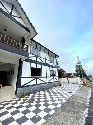 a black and white building with a checkered floor at Bukit Cottage - bungalow style in Tanah Rata