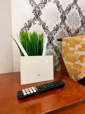 a remote control sitting on a table next to a laptop at Bukit Cottage - bungalow style in Tanah Rata