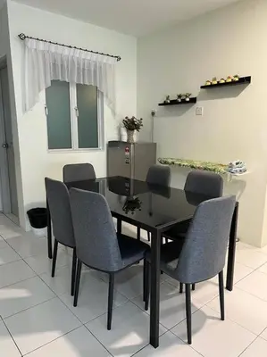 a dining room with a black table and chairs at Arcadia Homes 3A The Quintet, Cameron Highlands in Tanah Rata