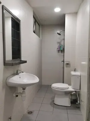 a white bathroom with a toilet and a sink at Arcadia Homes 3A The Quintet, Cameron Highlands in Tanah Rata