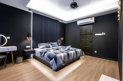 a black bedroom with a bed and a desk at 4Rooms Elegance Dream House - 5Mins to Icon City in Bukit Mertajam