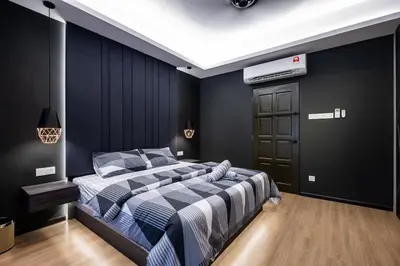 a bedroom with a bed and a black wall at 4Rooms Elegance Dream House - 5Mins to Icon City in Bukit Mertajam