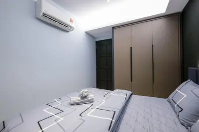 a bedroom with a bed with a air conditioner on the wall at 4Rooms Elegance Dream House - 5Mins to Icon City in Bukit Mertajam