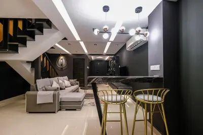 a living room with a couch and two bar stools at 4Rooms Elegance Dream House - 5Mins to Icon City in Bukit Mertajam