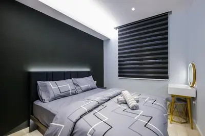 a bedroom with a large bed with a black wall at 4Rooms Elegance Dream House - 5Mins to Icon City in Bukit Mertajam