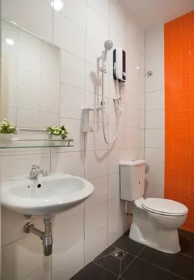 a bathroom with a toilet and a sink at Big Orange Hotel Sungai Petani in Sungai Petani