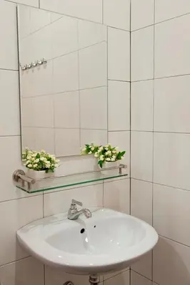a bathroom with a sink and a mirror at Big Orange Hotel Sungai Petani in Sungai Petani