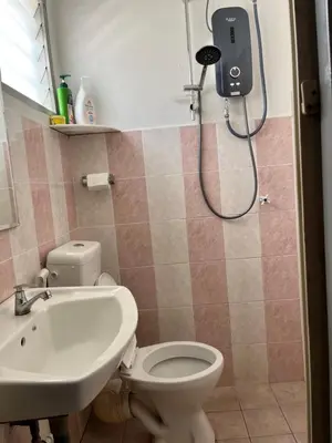 a bathroom with a shower and a toilet and a sink at Station 18 Homestay 3R3B in Ipoh