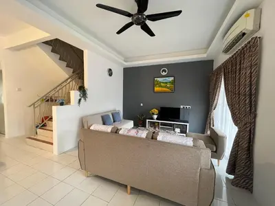 a living room with a couch and a ceiling fan at Station 18 Homestay 3R3B in Ipoh
