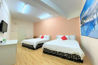 a hotel room with two beds and a tv at B Hotel Penang in George Town