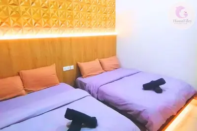 two beds in a room with purple sheets at The Majestic Condo Ipoh Home Fairy 2 in Ipoh