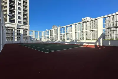 a tennis court in the middle of a building at Straits Quay Highest Floor PoolView Suite in Tanjong Tokong