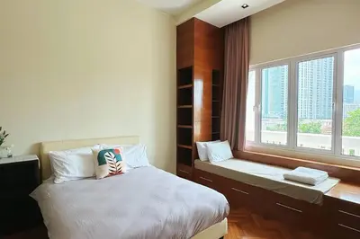 a bedroom with a large bed and a window at Straits Quay Highest Floor PoolView Suite in Tanjong Tokong