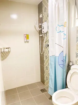 a bathroom with a shower and a toilet at The Floral Dawn Anderson in Kampong Simee