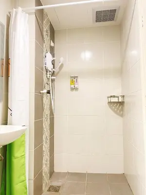 a shower with a glass door in a bathroom at The Floral Dawn Anderson in Kampong Simee