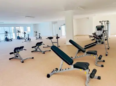 a gym with several exercise bikes in a room at The Floral Dawn Anderson in Kampong Simee
