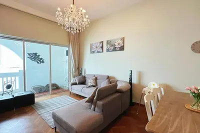 a living room with a couch and a table at Straits Quay Highest Floor Infinity SeaView Suite in Tanjong Tokong