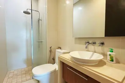a bathroom with a sink and a toilet and a shower at Straits Quay Highest Floor Infinity SeaView Suite in Tanjong Tokong
