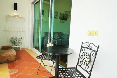 a black table and chairs in a room at Straits Quay Highest Floor Infinity SeaView Suite in Tanjong Tokong