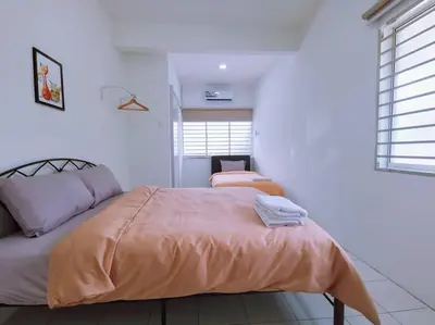a bedroom with a bed with an orange blanket at Gioia DeGarden in Taiping