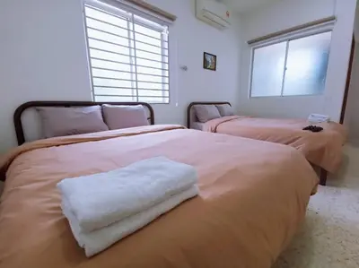a bedroom with two beds with white towels on them at Gioia DeGarden in Taiping