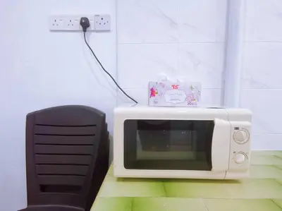 a microwave with a box on top of it at Gioia DeGarden in Taiping