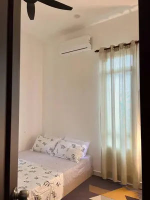 a bedroom with a bed and a ceiling fan at Homestay Dataran Tikam Batu in Sungai Petani