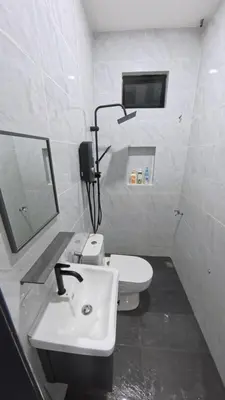 a white bathroom with a sink and a toilet at Homestay Dataran Tikam Batu in Sungai Petani