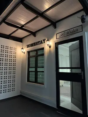 a room with a door and a sign on the wall at Homestay Dataran Tikam Batu in Sungai Petani