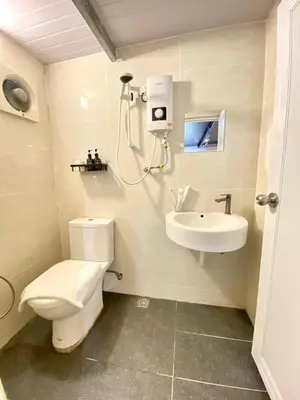 a bathroom with a toilet and a sink at Bayu Bayu Hotel by Soft Loft in Tanjung Bungah