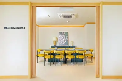 a dining room with a table and yellow chairs at Cititel Express Ipoh in Ipoh