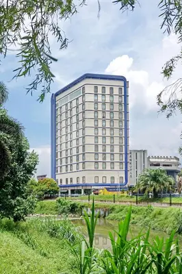 a tall white building with a blue roof at Cititel Express Ipoh in Ipoh