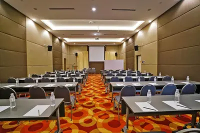 a conference room with tables and chairs and a podium at Cititel Express Ipoh in Ipoh