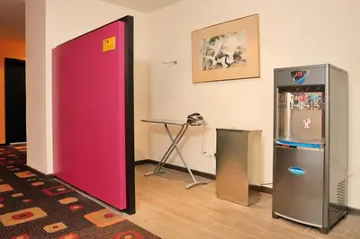 a room with two refrigerators sitting next to a table at Cititel Express Ipoh in Ipoh