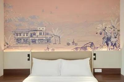 a bedroom with a painting on the wall above a bed at Cititel Express Ipoh in Ipoh