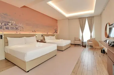 a hotel room with two beds and a television at Cititel Express Ipoh in Ipoh