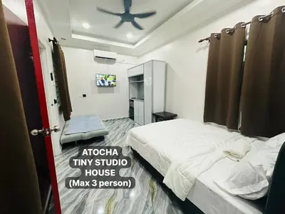 a bedroom with a bed and a ceiling fan at Atocha Tiny Studio House - Temerlok Terong, Perak - max 3 person only in Kampong Salak