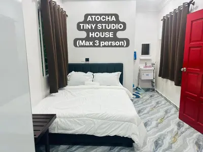 a bedroom with a bed and a sign on the wall at Atocha Tiny Studio House - Temerlok Terong, Perak - max 3 person only in Kampong Salak