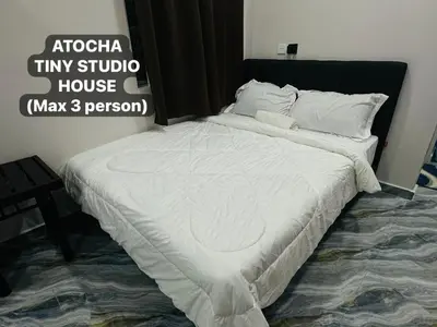 a large bed in a bedroom with aigiligiligiltiny stupid at Atocha Tiny Studio House - Temerlok Terong, Perak - max 3 person only in Kampong Salak
