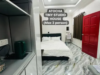 a bedroom with a bed with a red door and a mirror at Atocha Tiny Studio House - Temerlok Terong, Perak - max 3 person only in Kampong Salak