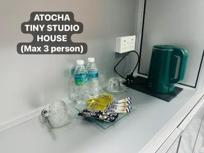 a bathroom counter with a mirror and bottles of water at Atocha Tiny Studio House - Temerlok Terong, Perak - max 3 person only in Kampong Salak