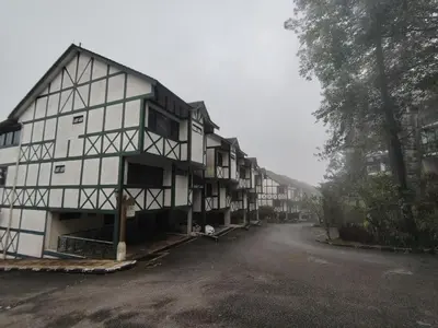 a large white building on the side of a road at Cozy Nest 1 Bedroom Apartment at Equatorial Hill Resort in Brinchang