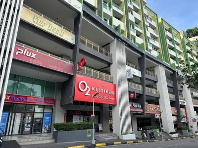 a large building with signs on the side of it at Fabulous Airport 2BR Suite# Straits Intl# Msg Chair in Bayan Lepas